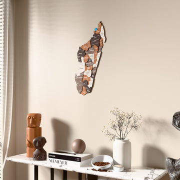 Soil Madagascar wooden wall map beside a sheer curtain, angled view
