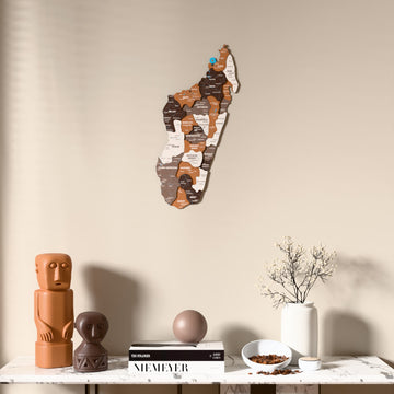 Soil Madagascar wooden wall map above a marble console, front view