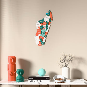 Flag colored Madagascar wooden wall map above a marble console, front view