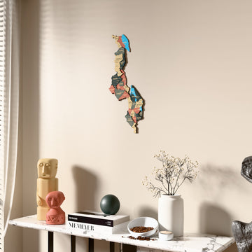 Sage Malawi wooden wall map beside a sheer curtain, angled view