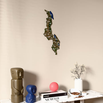 Satellite Malawi wooden wall map on a beige wall above a console with figurines