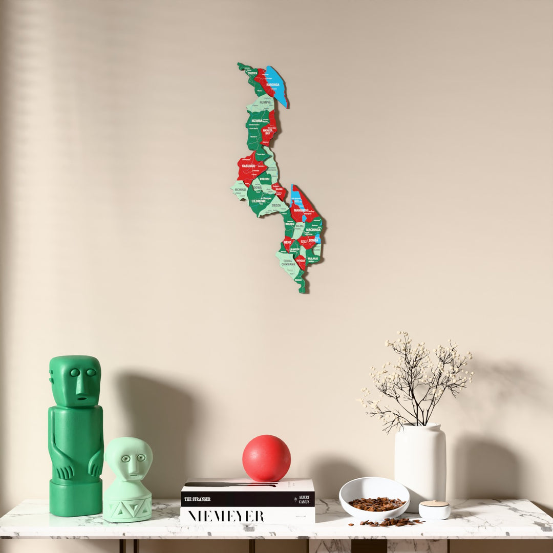 Flag colored Malawi wooden wall map above a marble console, front view