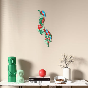 Flag colored Malawi wooden wall map above a marble console, front view