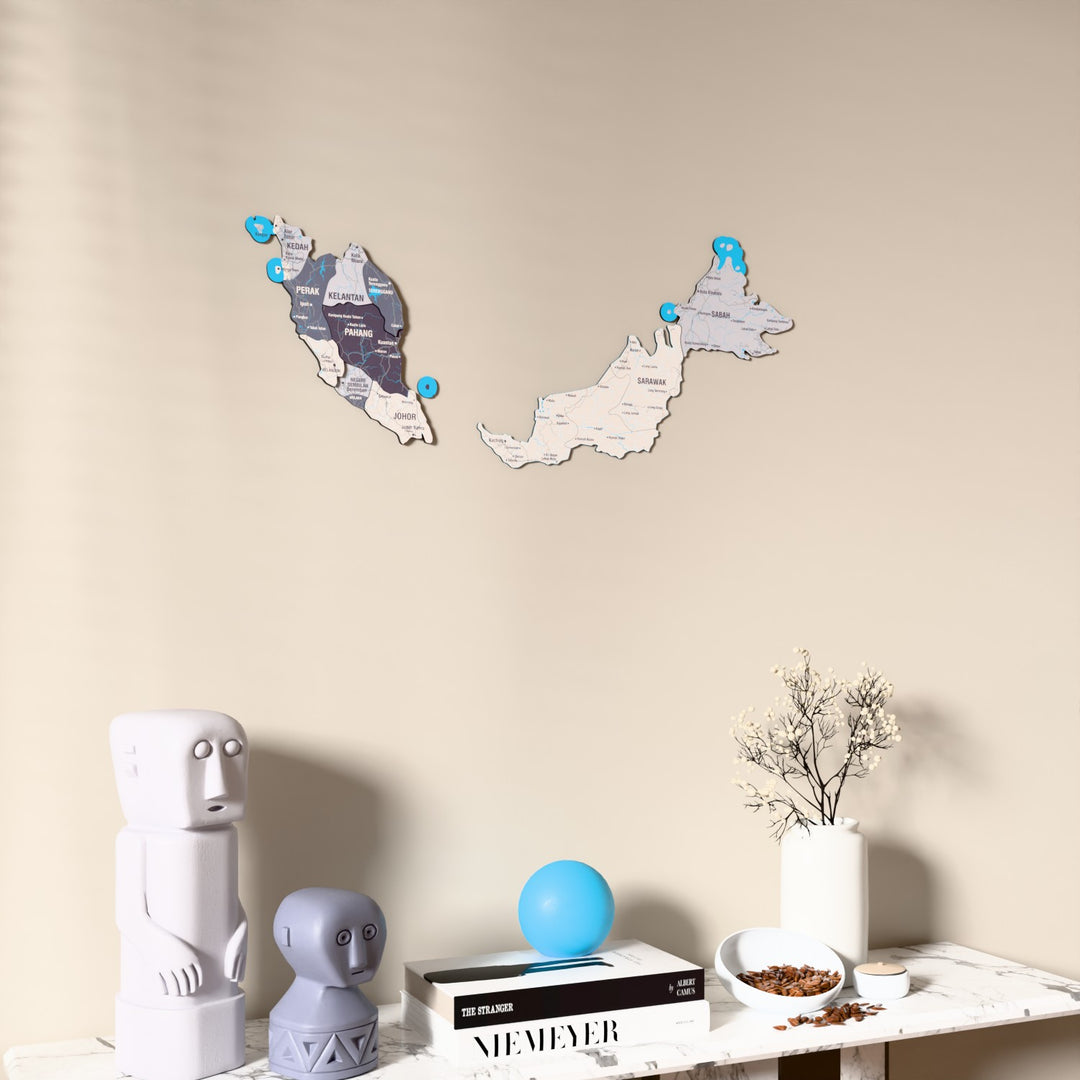 Nimbus Malaysia wooden wall map on a beige wall above a console with figurines