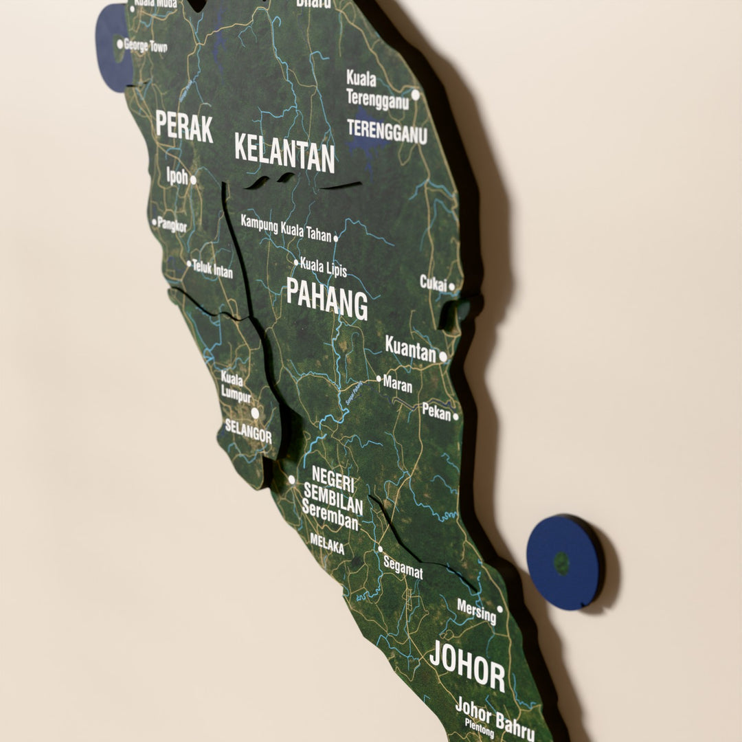Close-up of the Satellite Malaysia wooden wall map with layered regions and printed names
