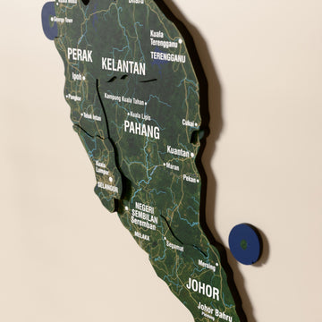 Close-up of the Satellite Malaysia wooden wall map with layered regions and printed names