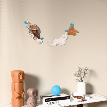 Soil Malaysia wooden wall map on a beige wall above a console with figurines