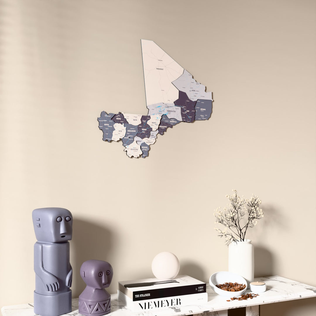 Nimbus Mali wooden wall map on a beige wall above a console with figurines