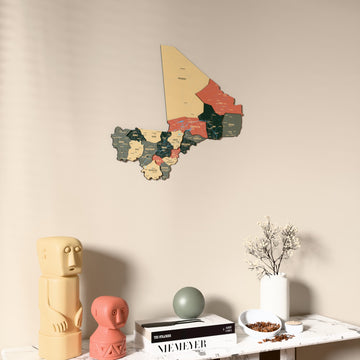 Sage Mali wooden wall map on a beige wall above a console with figurines