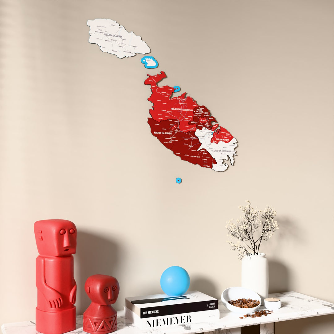 Flag colored Malta wooden wall map on a beige wall above a console with figurines
