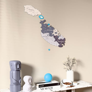 Nimbus Malta wooden wall map on a beige wall above a console with figurines