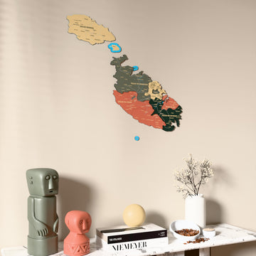 Sage Malta wooden wall map on a beige wall above a console with figurines