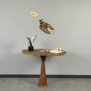 Wooden Malta map above a live-edge wood table with a black vase