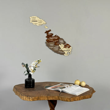 Malta wood wall map above a live-edge table, close crop of the table with a book and fruit