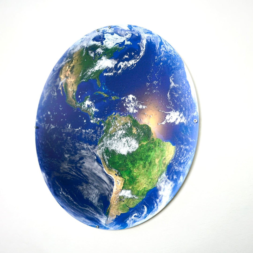 UV-printed metal wall art of Earth showing the Americas from space, tilted oval view