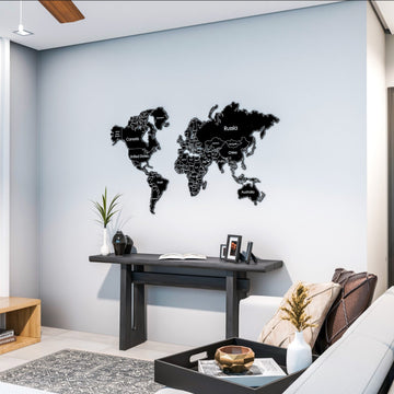 Black metal world map above a dark console table in a living room corner