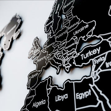 Close-up of Europe and Turkey with white country outlines on the black metal world map