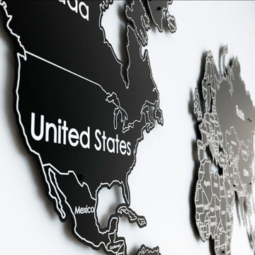 Close-up of North America with the United States and Mexico outlined in white on the black metal world map