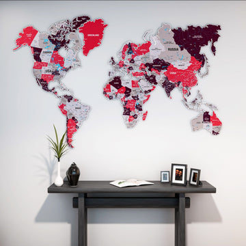 Crimson metal world map above a dark console table with framed photos, front view