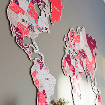 Angled view of the Americas and Eurasia on the crimson metal world map, tall crop