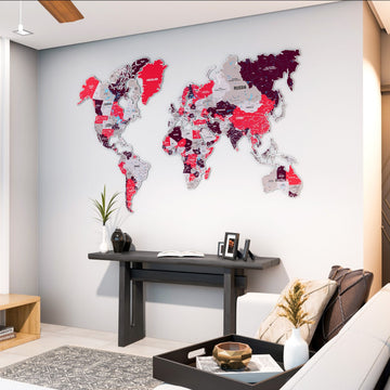 Crimson metal world map above a dark console table in a living room corner, wide view