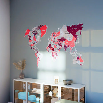 Crimson metal world map above a glass-door cabinet, wide view with window light on the wall