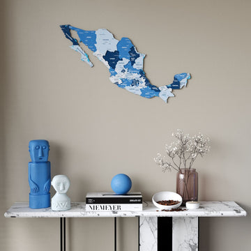 Navy Mexico wooden wall map in shades of blue above a marble console table, front view