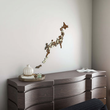 Wooden Japan wall map above a dark wood dresser with a decorative vase, wide room view