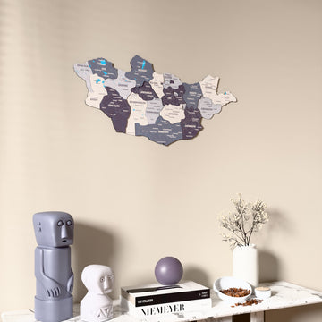 Nimbus Mongolia wooden wall map on a beige wall above a console with figurines