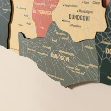 Close-up of the Sage Mongolia wooden wall map with layered regions and printed names