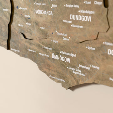 Close-up of the Satellite Mongolia wooden wall map with layered regions and printed names