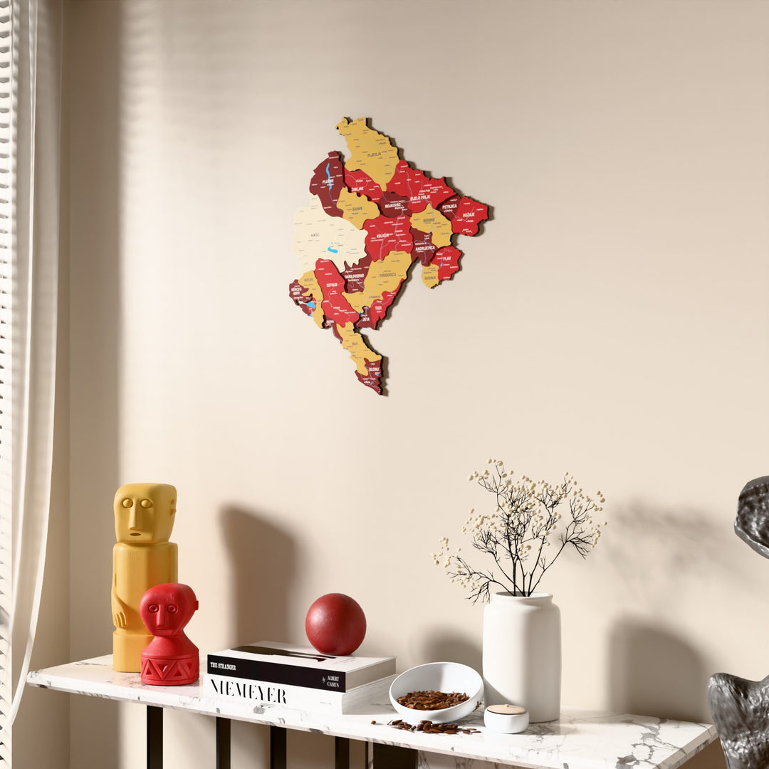 Flag colored Montenegro wooden wall map beside a sheer curtain, angled view