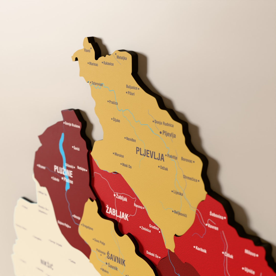 Close-up of the Flag colored Montenegro wooden wall map with layered regions and printed names