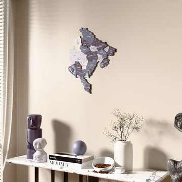 Nimbus Montenegro wooden wall map beside a sheer curtain, angled view