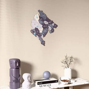 Nimbus Montenegro wooden wall map on a beige wall above a console with figurines