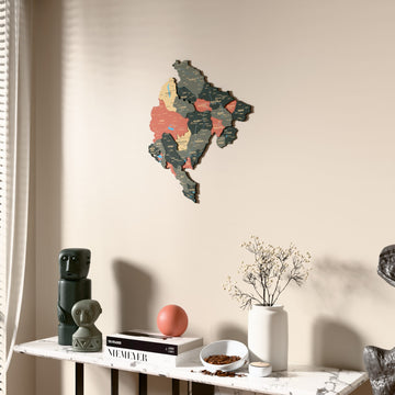 Sage Montenegro wooden wall map beside a sheer curtain, angled view