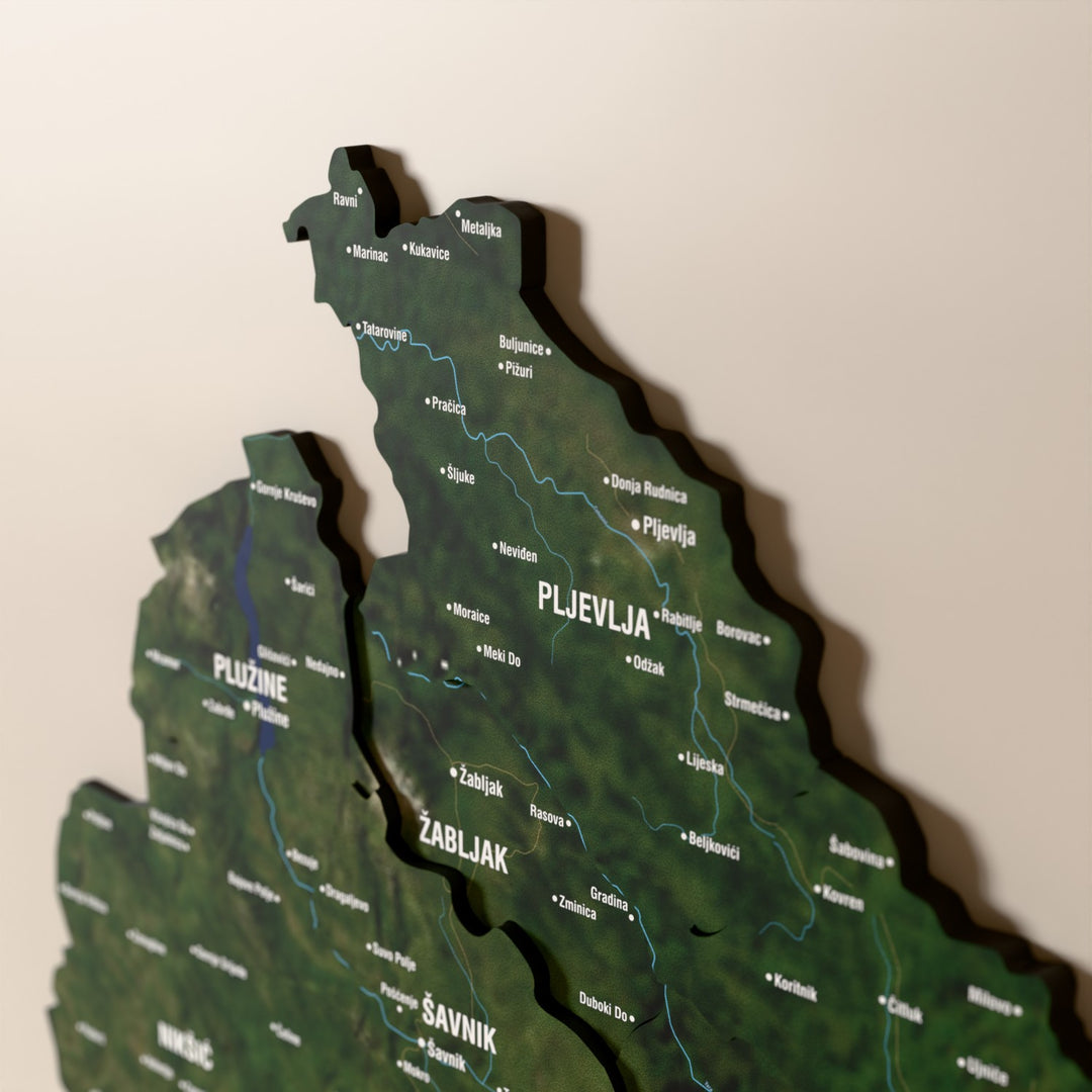 Close-up of the Satellite Montenegro wooden wall map with layered regions and printed names