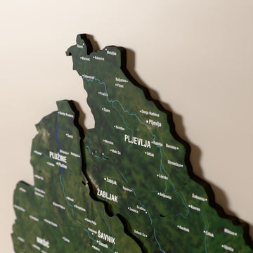 Close-up of the Satellite Montenegro wooden wall map with layered regions and printed names