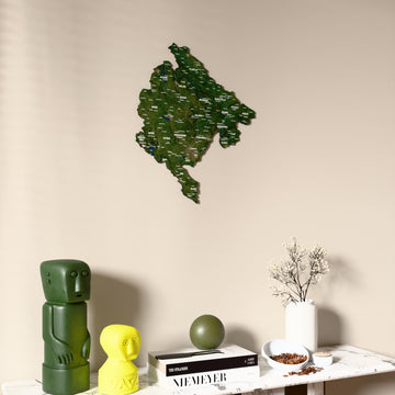 Satellite Montenegro wooden wall map on a beige wall above a console with figurines