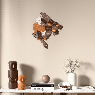 Soil Montenegro wooden wall map above a marble console, front view