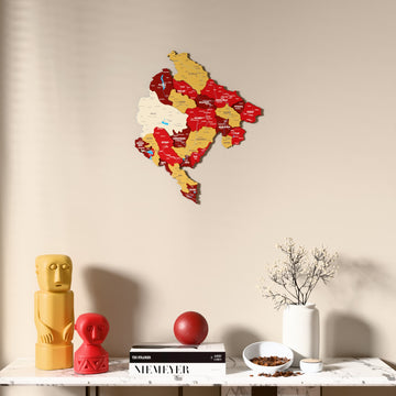 Flag colored Montenegro wooden wall map above a marble console, front view