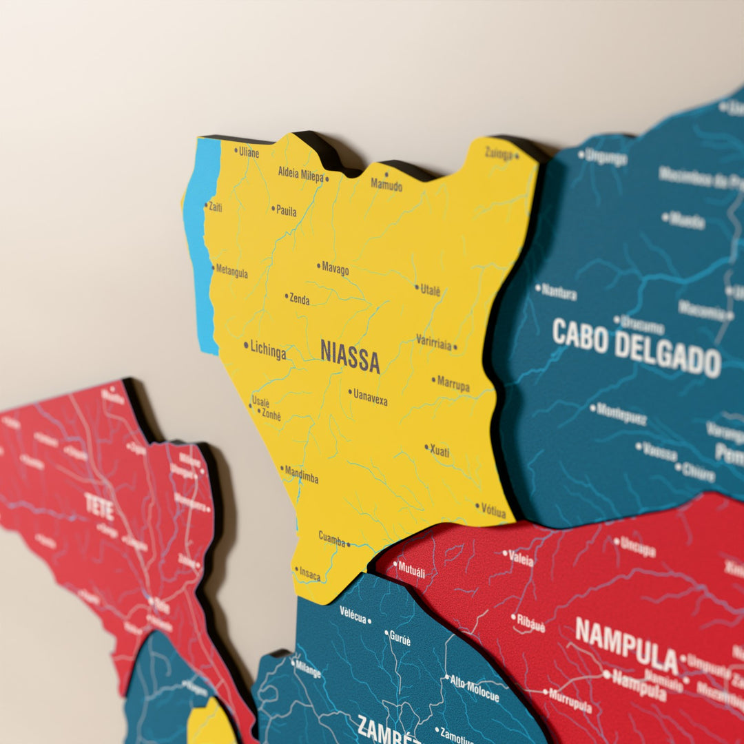 Close-up of the Flag colored Mozambique wooden wall map with layered regions and printed names
