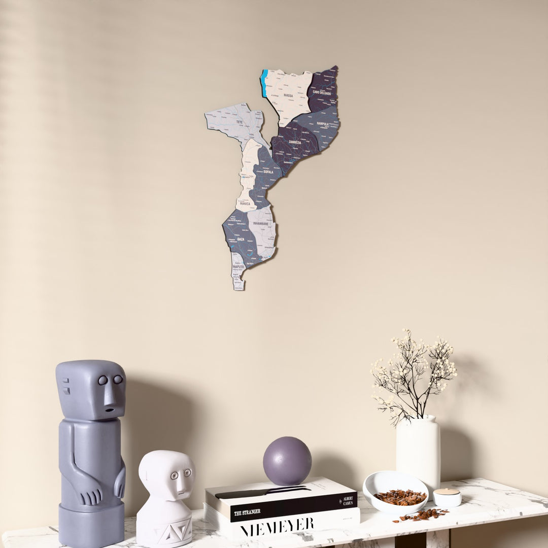 Nimbus Mozambique wooden wall map on a beige wall above a console with figurines