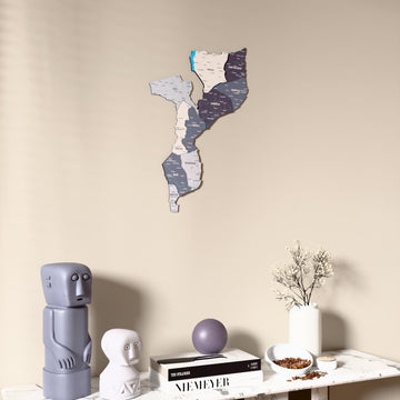 Nimbus Mozambique wooden wall map on a beige wall above a console with figurines