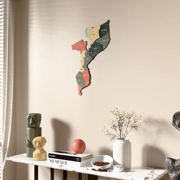Sage Mozambique wooden wall map beside a sheer curtain, angled view