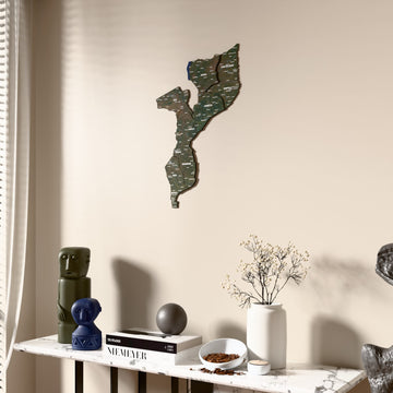 Satellite Mozambique wooden wall map beside a sheer curtain, angled view