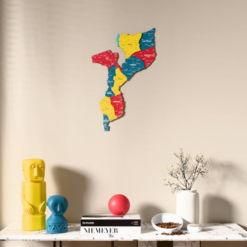 Flag colored Mozambique wooden wall map above a marble console, front view