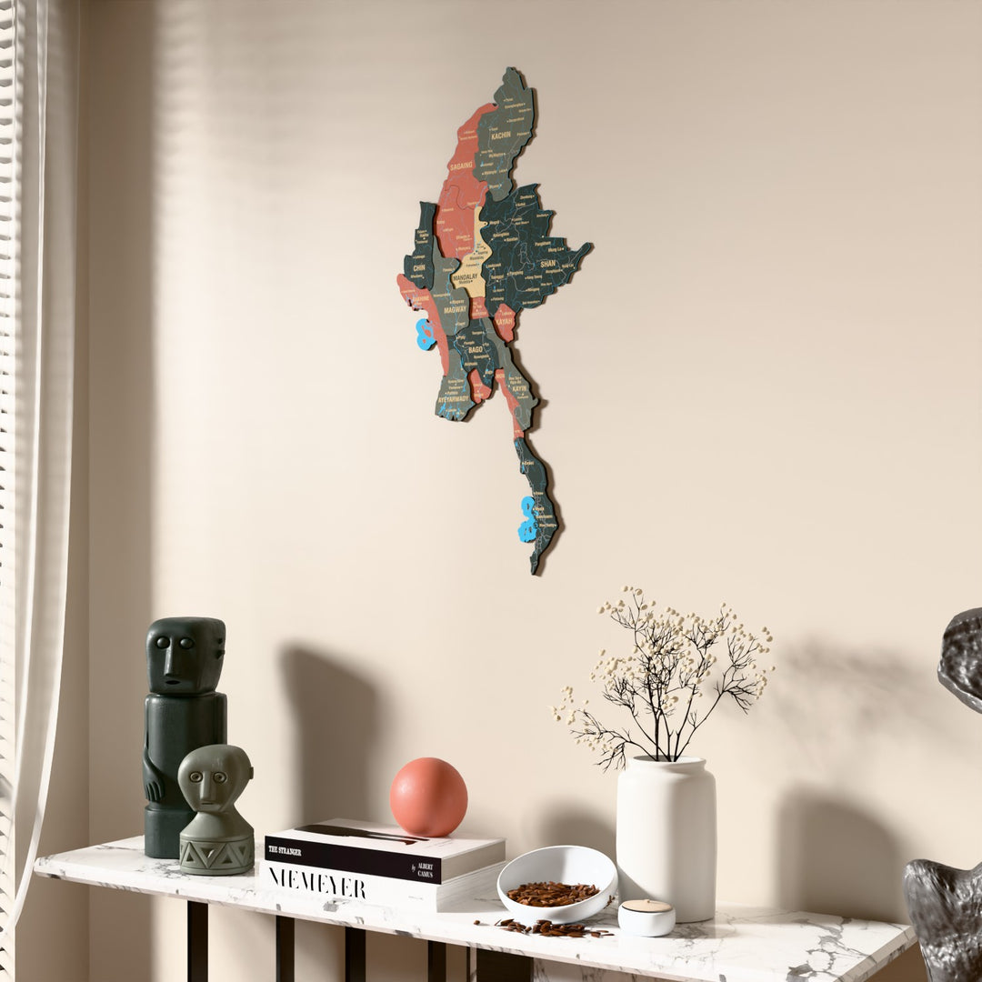 Sage Myanmar wooden wall map beside a sheer curtain, angled view