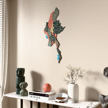 Sage Myanmar wooden wall map beside a sheer curtain, angled view