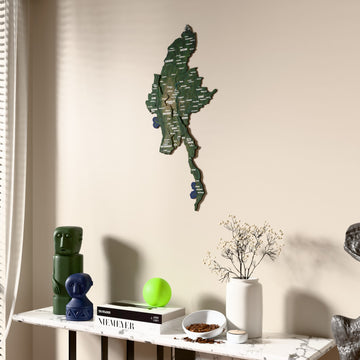 Satellite Myanmar wooden wall map beside a sheer curtain, angled view
